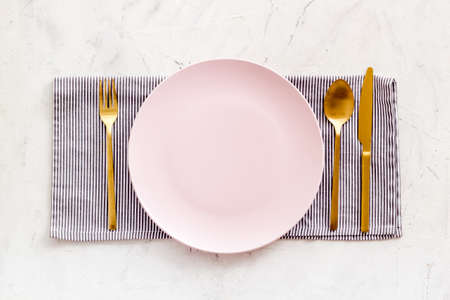 White plate with fork and knife on table napkin. Table settingの写真素材