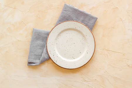 Table setting for dinner. Empty plate on napkin - dishware top viewの写真素材