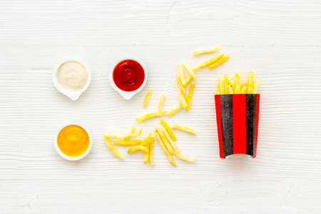 Patatoes french fries in red paper box with different saucesの写真素材
