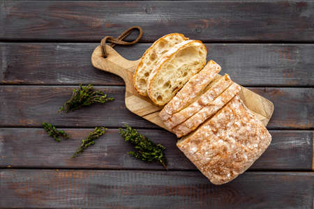 Sliced bread ciabatta with rosemary. Breakfast backgroundの写真素材