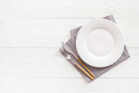 Table setting overhead view - plate with cutlery set and napkin