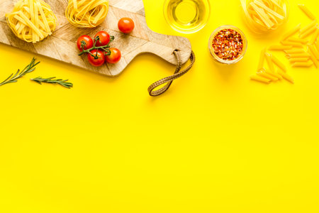 Flat lay of pasta ingredients with tomatoes olive oil spicesの写真素材