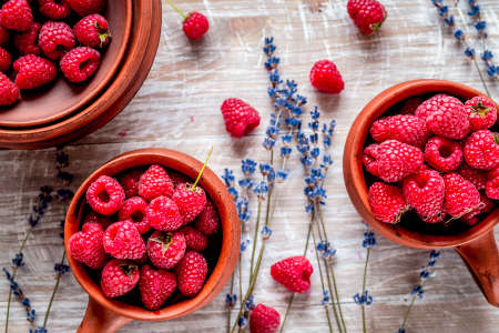 fresh raspberry and dry lavander in rustic design wooden background top viewの写真素材
