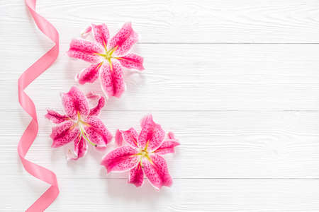 Pink lilies blossom flowers with purple ribbonの写真素材