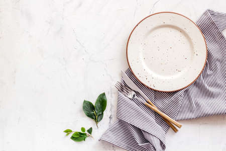 Dinner plate setting with cutlery and napkin. Top viewの写真素材