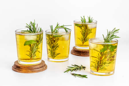 Fefreshing drink of cold tea and rosemary herbs in glassesの写真素材