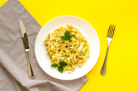 Italian pasta fettuccine with cream sauce and herbsの写真素材