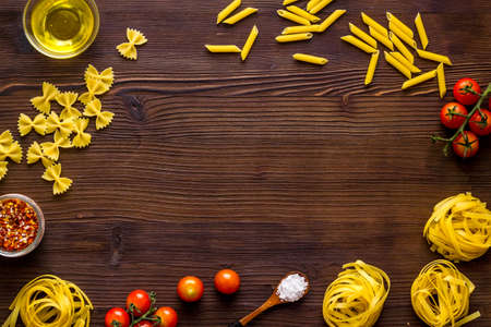 Frame of fettuccine with ingredients for cooking italian pastaの写真素材