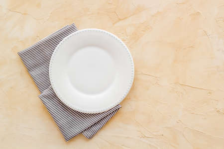 Top view of empty plate on napkin. Table setting for dinnerの写真素材