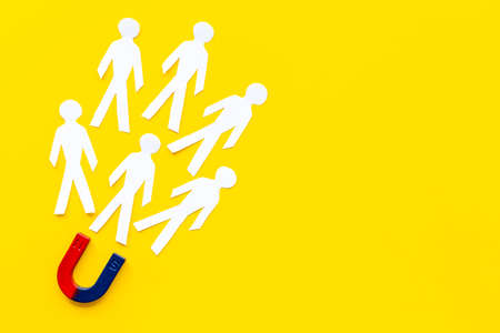 Corporate management team concept with horseshoe magnet and human figuresの写真素材
