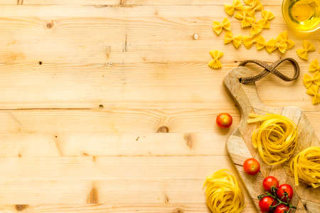 Fettuccine pasta with ingredients - tomatoes olive oil and herbs