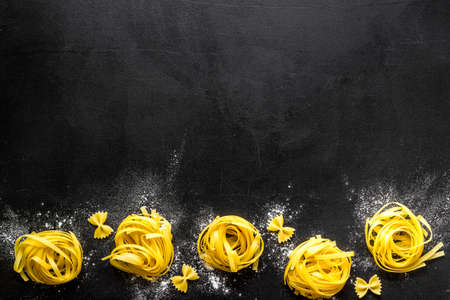 Fettuccine pasta pattern with flour, top view