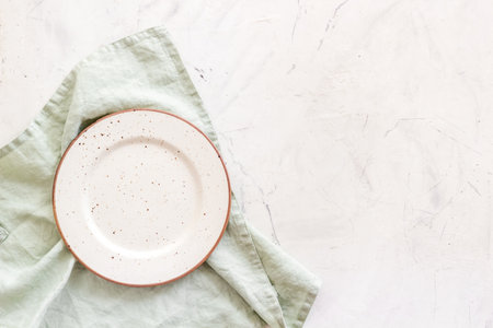 Top view of empty plate on napkin. Table setting for dinnerの写真素材
