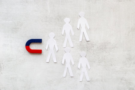 Corporate menegement team concept with horseshoe magnet and human figures