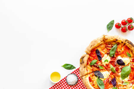 Italian pizza with tomatoes cheese and basil, top viewの写真素材