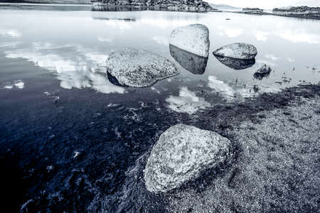 Blue lake idill under cloudline skyの写真素材