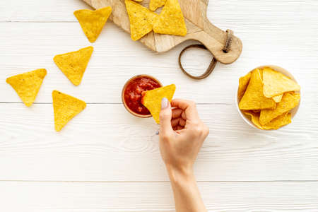 Mexican food nachos chips with tomato salsa sauce, top viewの写真素材