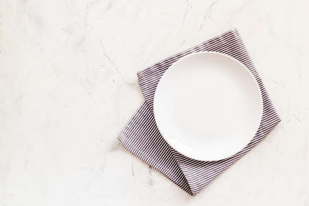Table setting top view. Empty plate on napkin - dishware for dinner