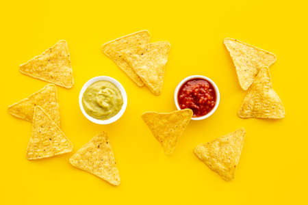Tortilla nachos chips with red tomato salsa and avocado guacamoleの写真素材