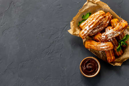 Treat churros with sugar served on baking paperの写真素材