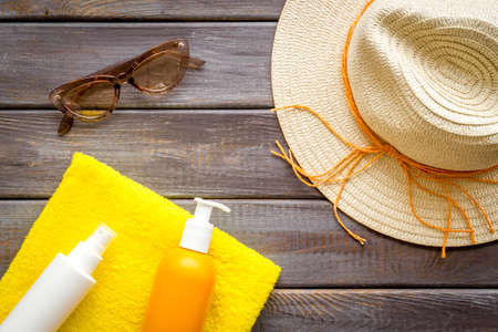Skin care with sunscreen. Sun lotion and suglasses with straw hatの写真素材