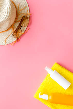 Skin care with sunscreen. Sun lotion and suglasses with straw hatの写真素材
