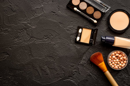 Makeup cosmetic products on black stone background, top viewの写真素材