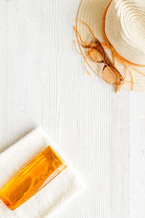 Summer beach vacation concept with straw hat and bottles od sunscreen
