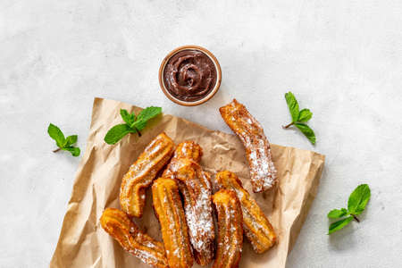 Treat churros with sugar served on baking paperの写真素材