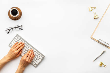 Woman hands working with computer on office table, top viewの写真素材