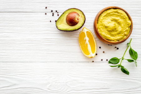 Guacamole dip in bowl with avocado and limeの写真素材