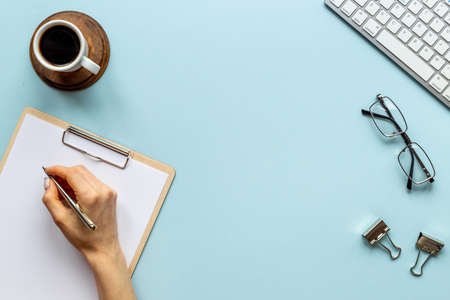 Woman hands working with computer on office table, top viewの写真素材