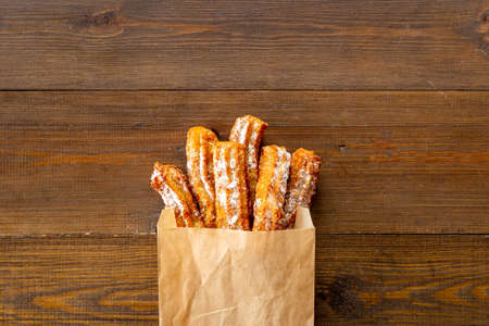 Treat churros with sugar served on baking paperの写真素材