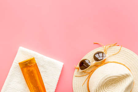 Summer beach vacation concept with straw hat and bottles od sunscreen