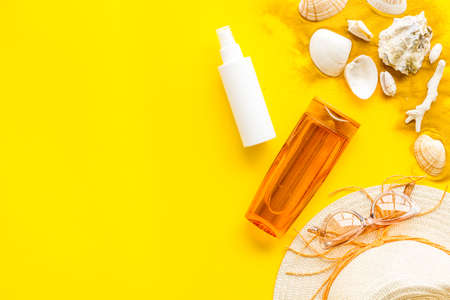 Flatlay of summer beach accessories with sand and seashells
