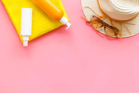 Summer beach vacation concept with straw hat and bottles od sunscreen