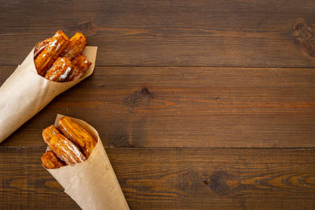 Fast food sweets - churros in paper bagの写真素材