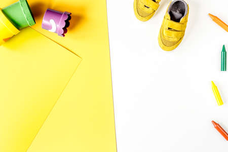 kid stylish set white and yellow colored background top view mock-upの写真素材