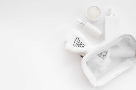 Set of cosmetic bag with white makeup bottles and tubes, top viewの写真素材