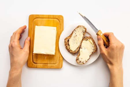 Slice of bread with butter, top view. Sandwiches with butterの写真素材