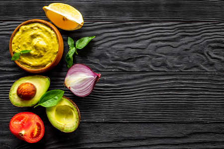 Bowl of guacamole dip with avocado and lime. Homemade guacamole concept