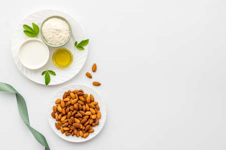 Sweet almond oil and milk with nuts seeds. Healthy food and cosmetic backgroundの写真素材