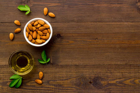 Almond nuts and almond oil in glass jar. Organic food and cosmetic backgroundの写真素材