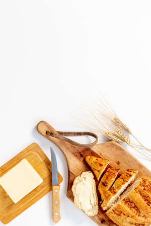 Loaf with dried fruits nuts and butter, top view