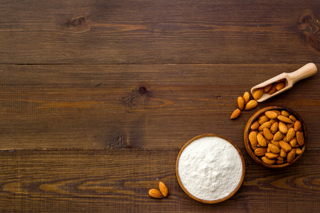Almond flour with almond nuts in bowl. Gluten free food ingredientの写真素材
