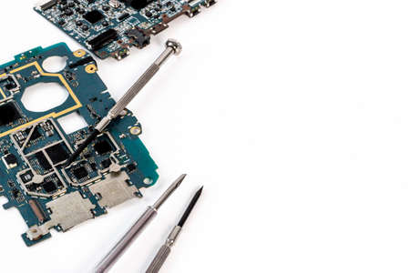 Electronics circuit board with microchips and tools, top viewの写真素材