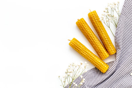 Honey aroma beeswax candles with leaves, top view. Eco home decor productの写真素材