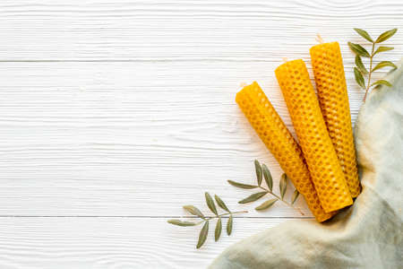 Natural eco home decor - honey aroma candles with leavesの写真素材