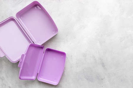 Empty purple lunch boxes, top view. Plastic container for foodの写真素材