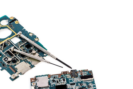 Electronics checkup - circuit board with microchips and tools, top view